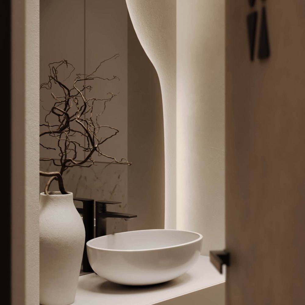 Elegant bathroom niche with sculptural sink, decorative vases, a